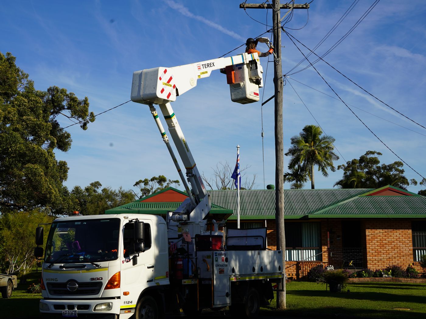 Intellergy crew working from an elevated work platform at a power pole