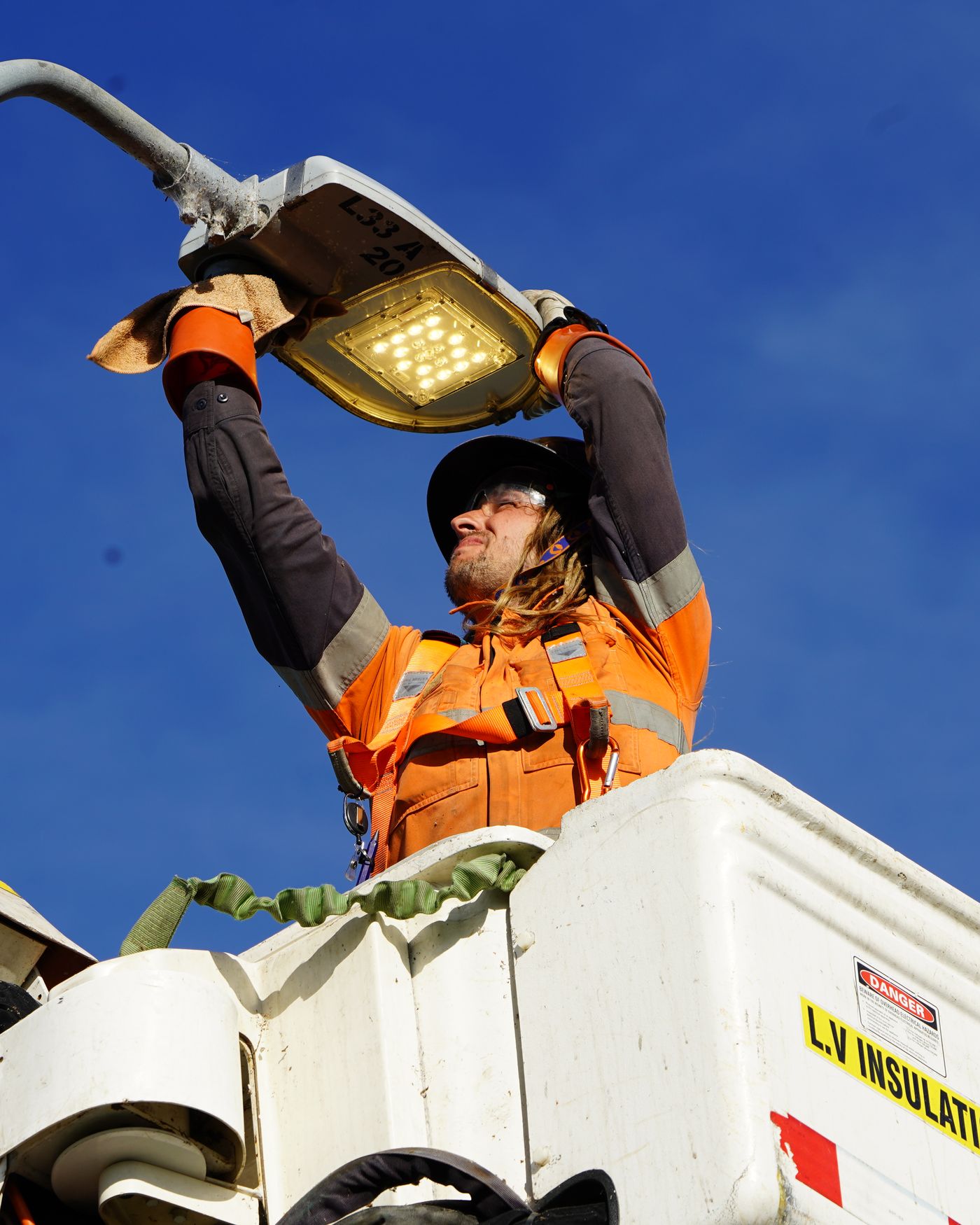 Intellergy crew working from an elevated work platform against the sky